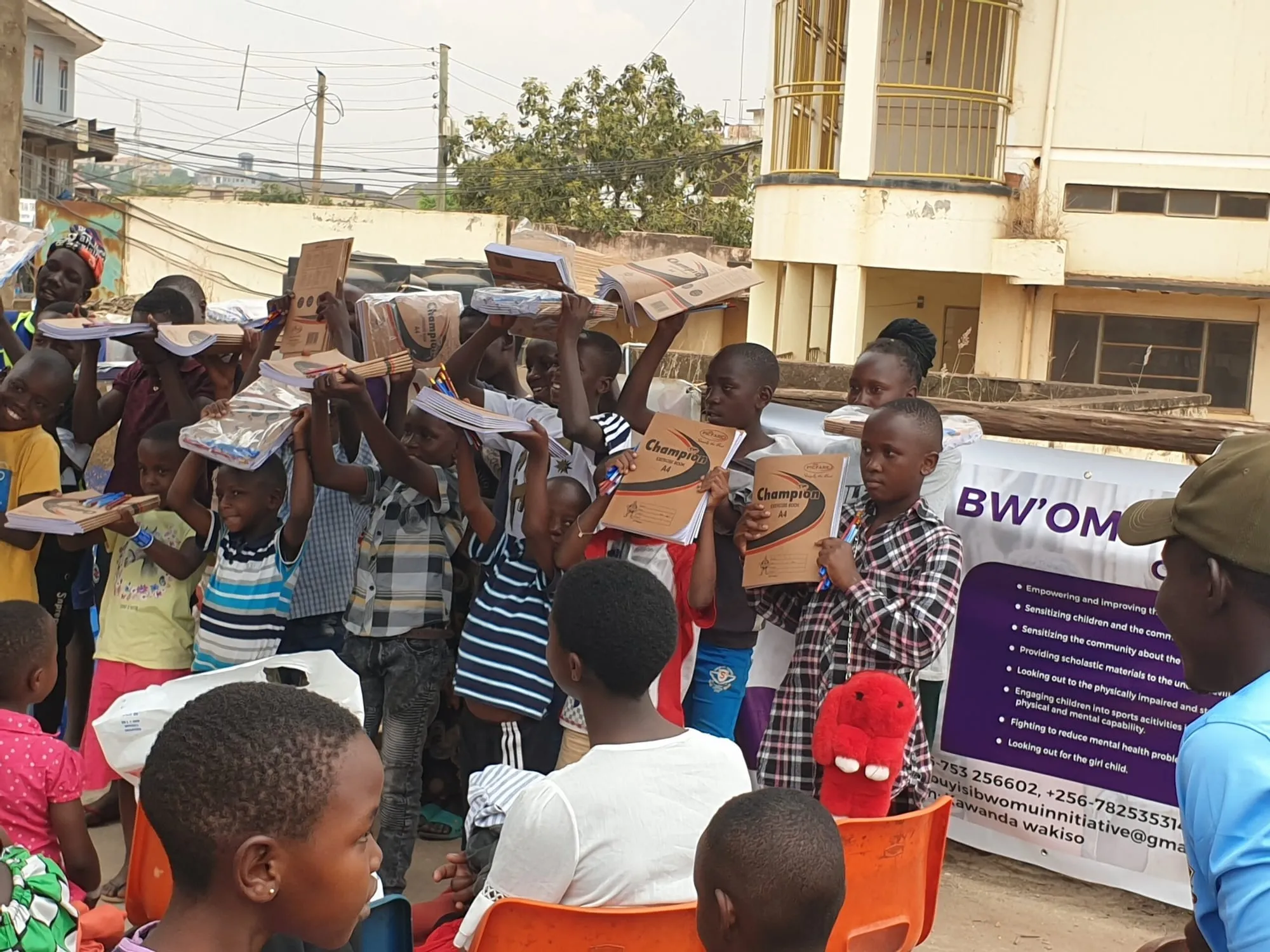 A crowd of children at a scholastic materials distribution in Bwaise