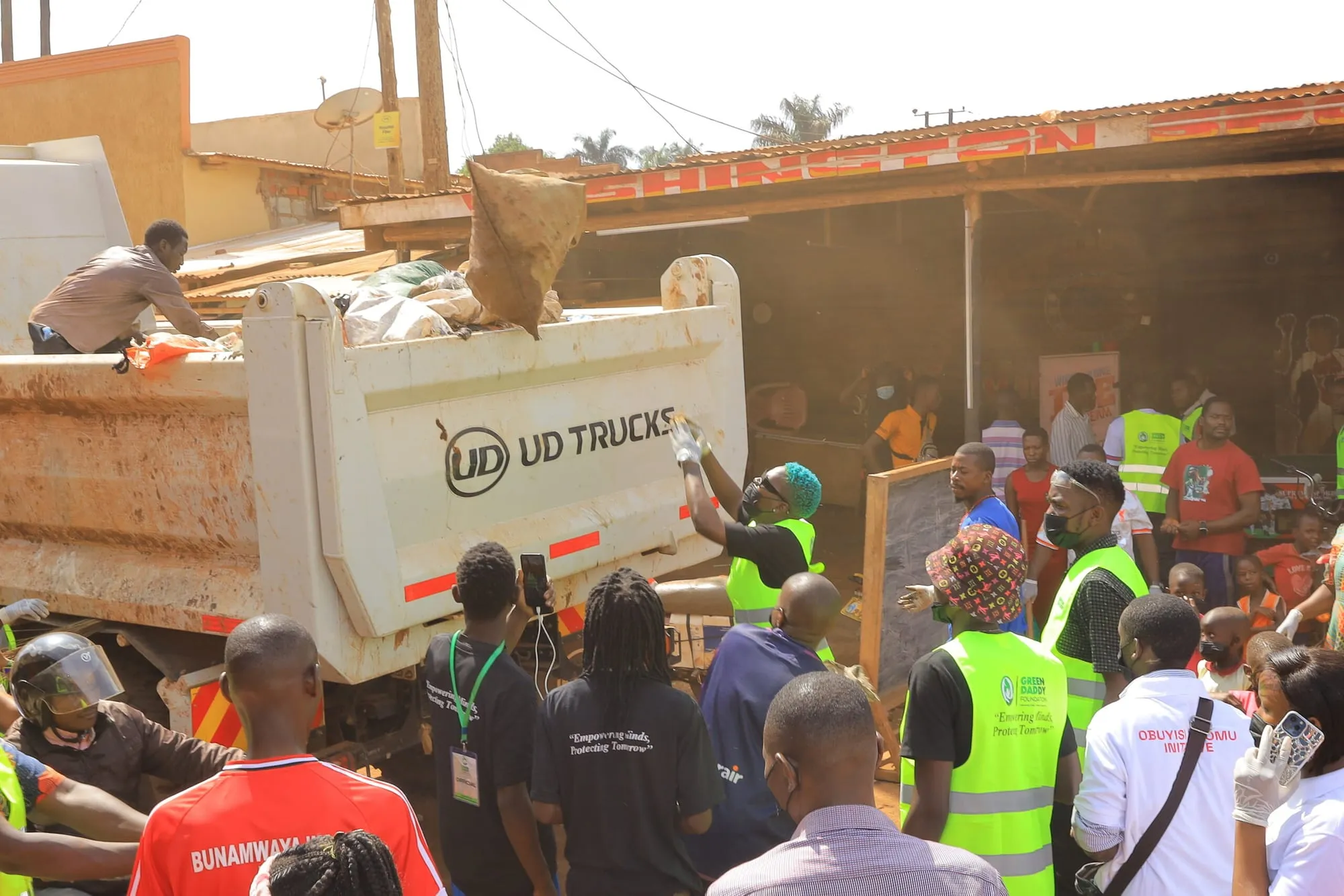 Volunteers loading collected waste onto a truck during a clean-up with Green Daddy Foundation